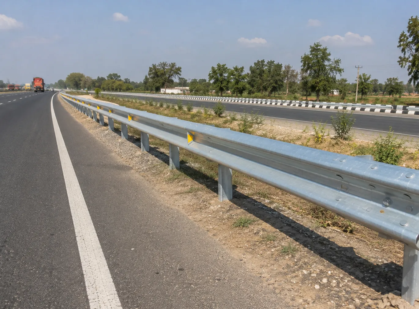 Galvanized crash barrier system along road corridor