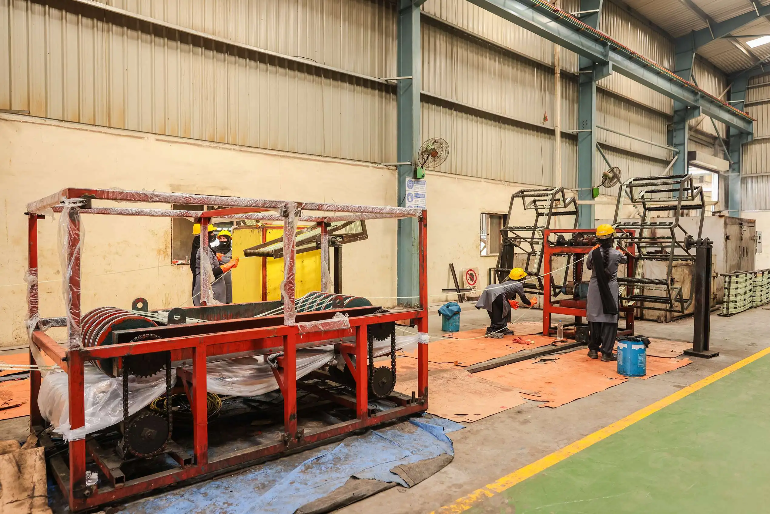Path Engineering technicians manufacturing GFRP reinforcement bars on a production line